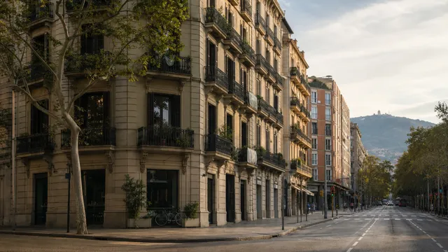 Eixample street with historic balconies, newer apartments and Montjuïc in the distance